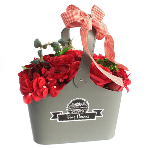 Gray basket with red soap flowers and a gingham ribbon, decorative gift arrangement